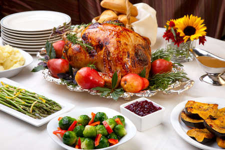 Delicious roasted turkey with savory vegetable side dishes in a fall themeの写真素材
