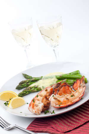 Closeup of delicious grilled lobster tails served with asparagus and bearnaise sauceの写真素材
