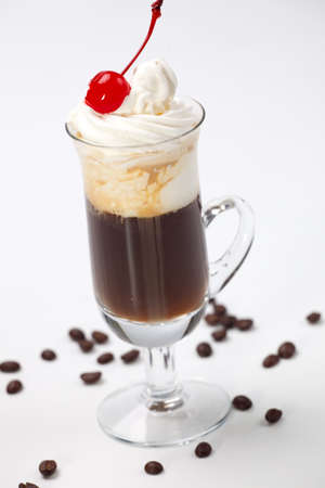 Closeup of tasty B-52 Coffee Cocktail, Baileys, Grand Marnier, Kahlua, coffee, whipped cream and maraschino cherry - Coffee Warmers seriesの写真素材