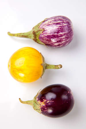 Fresh multi colored mini eggplants in rowの写真素材