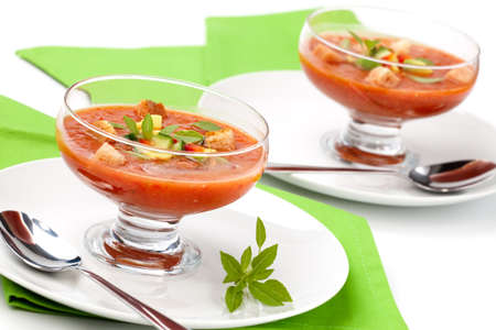 Two bowls of delicious cold Gazpacho soup with cucumber - avocado salsa. Good summer time appetizer.の写真素材