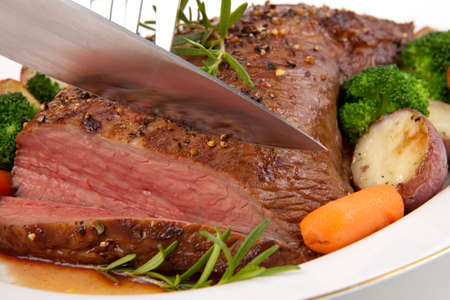 Roasted beef loin tri-tip, garnished with vegetablesの写真素材