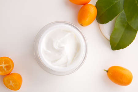 Closeup of jar of moisturizing face cream and fresh citrusの写真素材