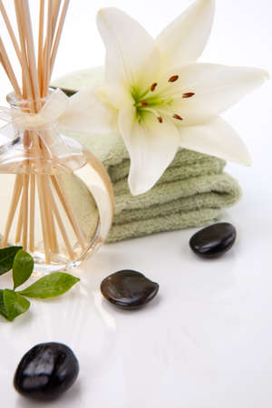 Aromatic spa set - Reed Diffuser and fresh white lily flower.の写真素材