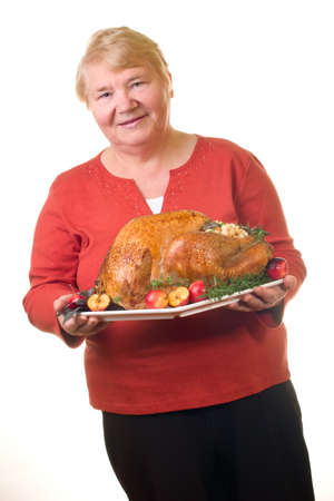 Garnished roasted turkey on platter is ready to be servedの写真素材