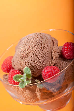 Closeup of delicious Chocolate Icecream with fresh raspberries and mint.の写真素材
