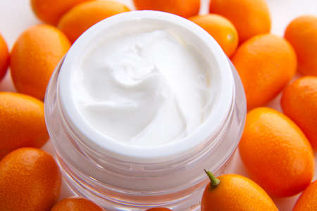 Closeup of jar of moisturizing face cream and fresh citrusの写真素材