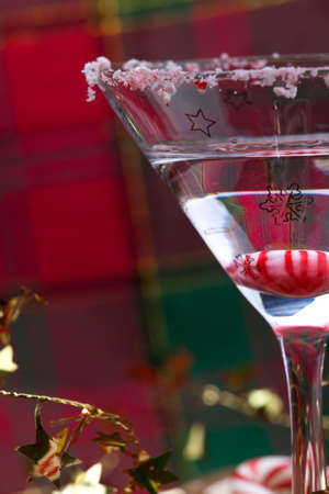Closeup of glass of Candy Cane Martini and Christmas ornamentsの写真素材