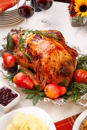 Delicious roasted turkey with savory vegetable side dishes in a fall themeの写真素材