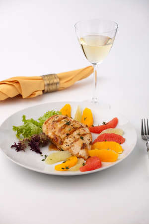 Grilled chicken breast with citrus salad - pink grapefruit, lime, orange, lettuce and fresh thyme.の写真素材