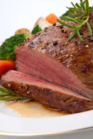 Roasted beef loin tri-tip, garnished with vegetablesの写真素材