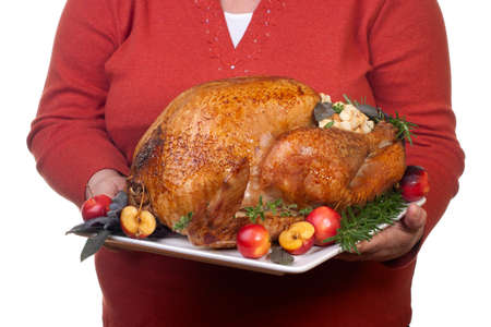 Garnished roasted turkey on platter is ready to be servedの写真素材