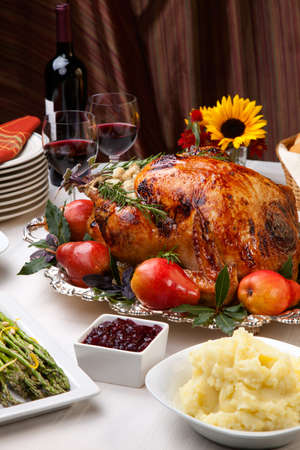 Delicious roasted turkey with savory vegetable side dishes in a fall themeの写真素材