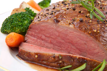 Roasted beef loin tri-tip, garnished with vegetablesの写真素材