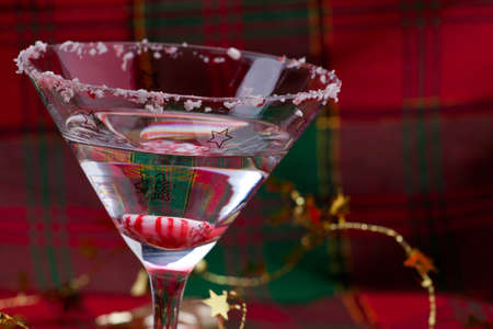 Closeup of glass of Candy Cane Martini and Christmas ornamentsの写真素材