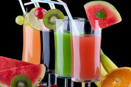 Glasses of organic juice made from fresh fruits and surrounded by fresh ones. Series about organic and healthy drinks.の写真素材