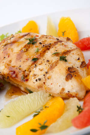 Grilled chicken breast with citrus salad - pink grapefruit, lime, orange, lettuce and fresh thyme.の写真素材