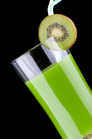 Organic juice made from kiwi, green grapes and bananas surrounded by fresh fruits. Series about organic and healthy drinks.の写真素材