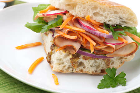 Delicious Turkey Breast Sandwich - rosemary ciabatta bread, turkey breast, whole grain mustard dressing, carrots, radish, red onion and parsley.の写真素材