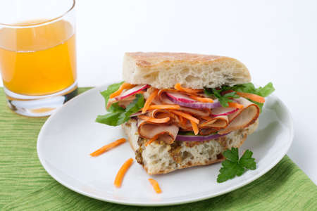 Delicious Turkey Breast Sandwich - rosemary ciabatta bread, turkey breast, whole grain mustard dressing, carrots, radish, red onion and parsley.の写真素材