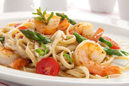 Healthy whole grain linguine with shrimps, asparagus, cherry tomatoes, fresh Parmesan cheese, and  oregano.の写真素材