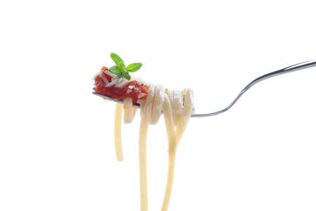 Healthy whole grain linguine with tomato sauce, and  parsley on fork isolated on whiteの写真素材