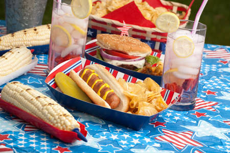 Hot dogs, corn and burgers on 4th of July picnic in patriotic themeの写真素材
