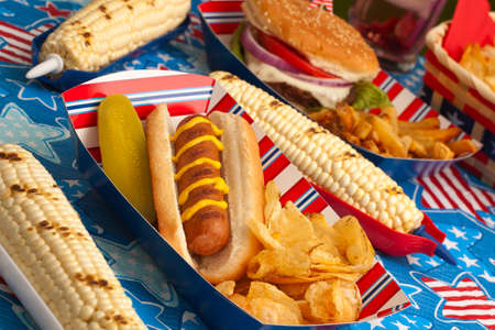 Hot dogs, corn and burgers on 4th of July picnic in patriotic themeの写真素材