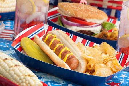 Hot dogs, corn and burgers on 4th of July picnic in patriotic themeの写真素材