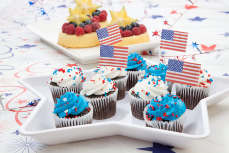 Chocolate muffins with white and blue icing on 4th of July in patriotic theme の写真素材