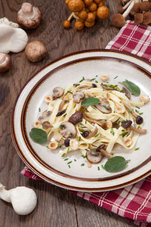 Wild mushrooms Linguini pasta with roasted hazelnut, sage, and chives.の写真素材