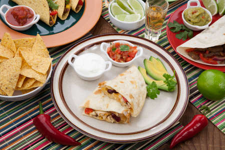 Assorted Mexican dishes, with chicken quesadilla as the main subject.の写真素材