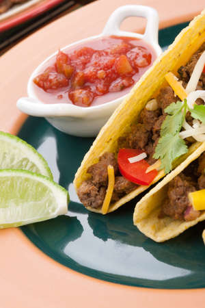 Assorted Mexican dishes, with whole grain corn beef tacos as the main subject.の写真素材