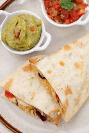 Assorted Mexican dishes, with chicken quesadilla as the main subject.の写真素材