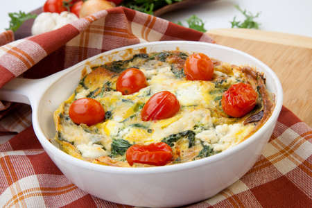 Closeup of pan with fresh made frittata with baby kale, sundried tomatoes, and goat cheese.の写真素材