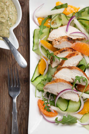 Southwest salad with sliced spicedrubbed roasted turkey tenderloins with creamy avocado dressing.の写真素材