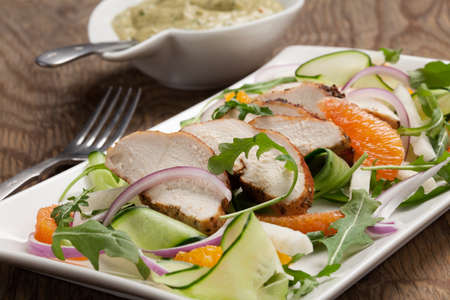 Southwest salad with sliced spicedrubbed roasted turkey tenderloins with creamy avocado dressing.の写真素材