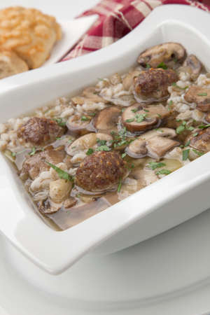 Hot delicious Mushroom Barley Soup with Mini Meatballs and cheese bread.の写真素材