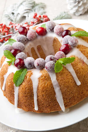 Traditional Christmas cranberry cake decorated with Christmas ornaments.の写真素材