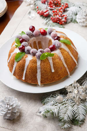 Traditional Christmas cranberry cake decorated with Christmas ornaments.の写真素材