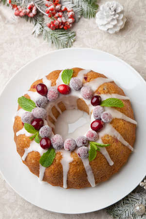 Traditional Christmas cranberry cake decorated with Christmas ornaments.の写真素材