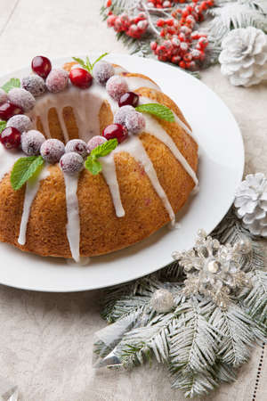 Traditional Christmas cranberry cake decorated with Christmas ornaments.の写真素材