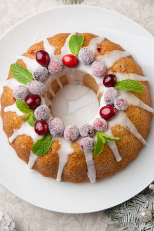Traditional Christmas cranberry cake decorated with Christmas ornaments.の写真素材