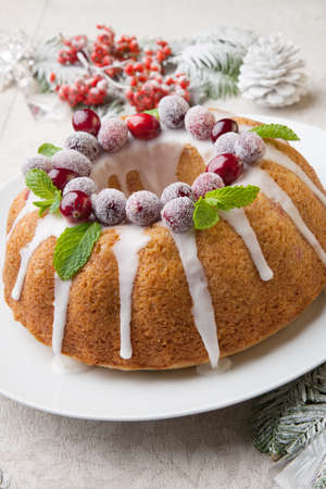Traditional Christmas cranberry cake decorated with Christmas ornaments.の写真素材