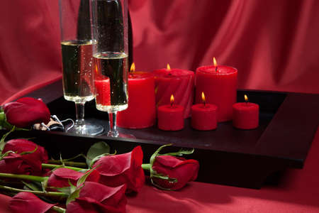 Celebration tray for Valentines Day - Champagne, chocolate raspberry cake, candles, and red roses.の写真素材