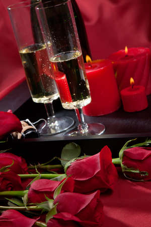 Celebration tray for Valentines Day - Champagne, chocolate raspberry cake, candles, and red roses.の写真素材