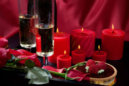Celebration tray for Valentines Day - Champagne, chocolate raspberry cake, candles, and red roses.の写真素材