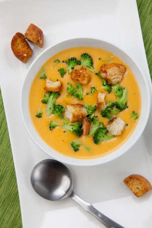 Close up of hot delicious broccoli - cheddar cheese soup with garlic croutons.の写真素材