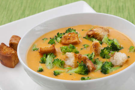 Close up of hot delicious broccoli - cheddar cheese soup with garlic croutons.の写真素材