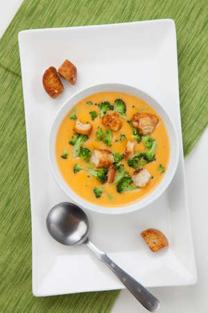 Close up of hot delicious broccoli - cheddar cheese soup with garlic croutons.の写真素材